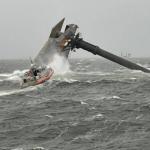 overturned barge in rough waters