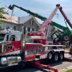 a construction forklift fallen on a house